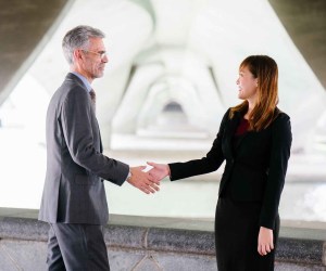 man and woman shaking hand in focus photography